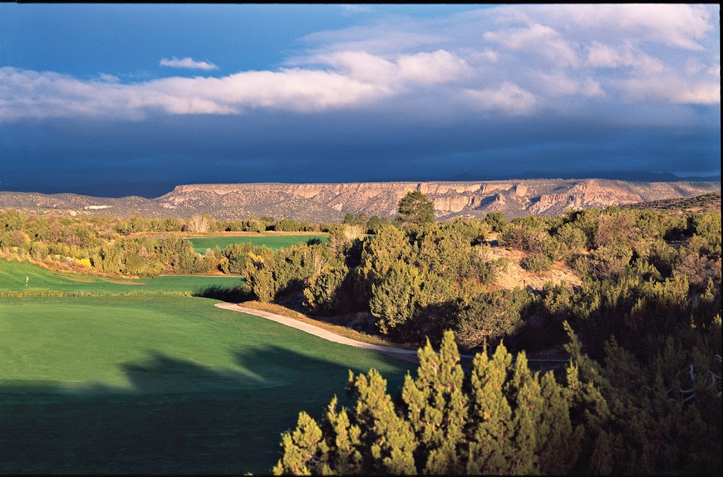 Panoramic view of a lush green golf course at Cochiti Golf Club. Smooth