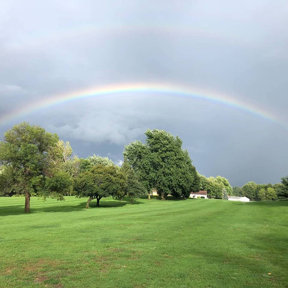 Panoramic view of a lush green golf course at Colfax Country Club. Smooth