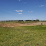 Panoramic view of a lush green golf course at Colockum Ridge Golf Course. Smooth