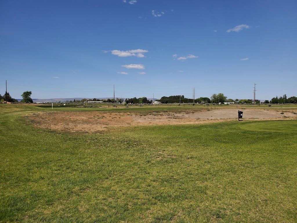 Panoramic view of a lush green golf course at Colockum Ridge Golf Course. Smooth