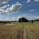 Panoramic view of a lush green golf course at Colorado Golf Club. Smooth