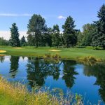 Panoramic view of a lush green golf course at Columbia Edgewater Country Club. Smooth