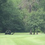 Panoramic view of a lush green golf course at Columbus Park Golf Course. Smooth