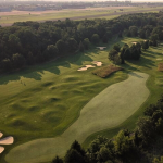 green grass with the flag in the hole.