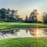 Panoramic view of a lush green golf course at Commonwealth National Golf Club. Smooth