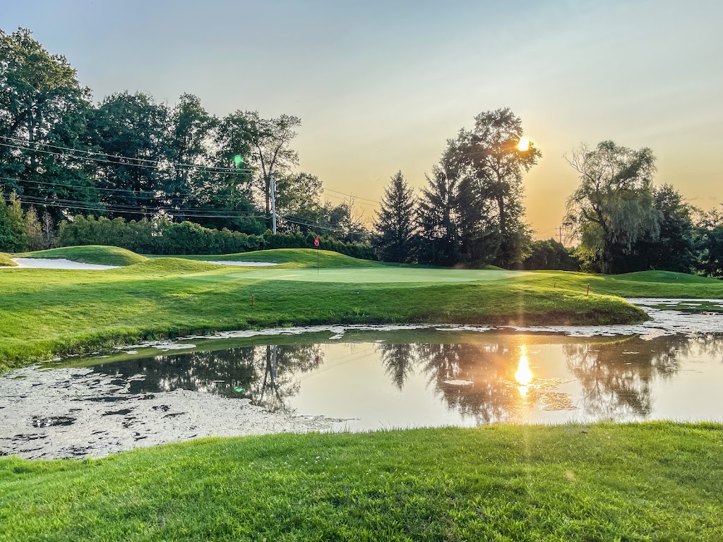 Panoramic view of a lush green golf course at Commonwealth National Golf Club. Smooth