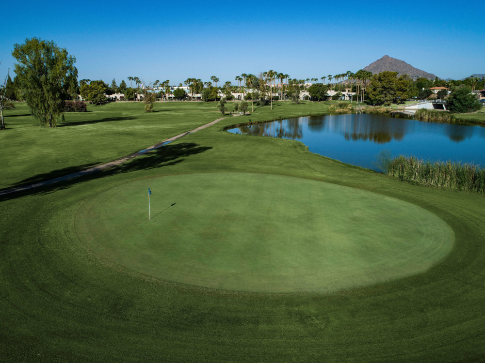 Panoramic view of a lush green golf course at Continental Golf Club. Smooth