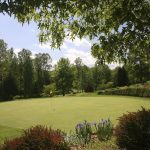 Panoramic view of a lush green golf course at Copper Cove Golf Club. Smooth