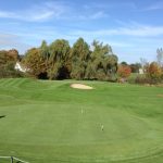 green grass with the flag in the hole.