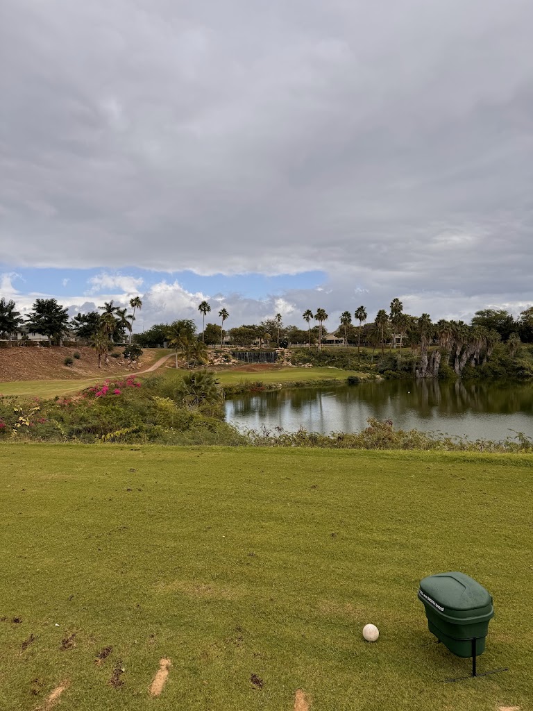 Panoramic view of a lush green golf course at Coral Creek Golf Course. Smooth