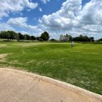 Panoramic view of a lush green golf course at Cottonwood Creek Golf Course. Smooth
