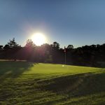 Panoramic view of a lush green golf course at Cotuit High Ground Golf Club. Smooth