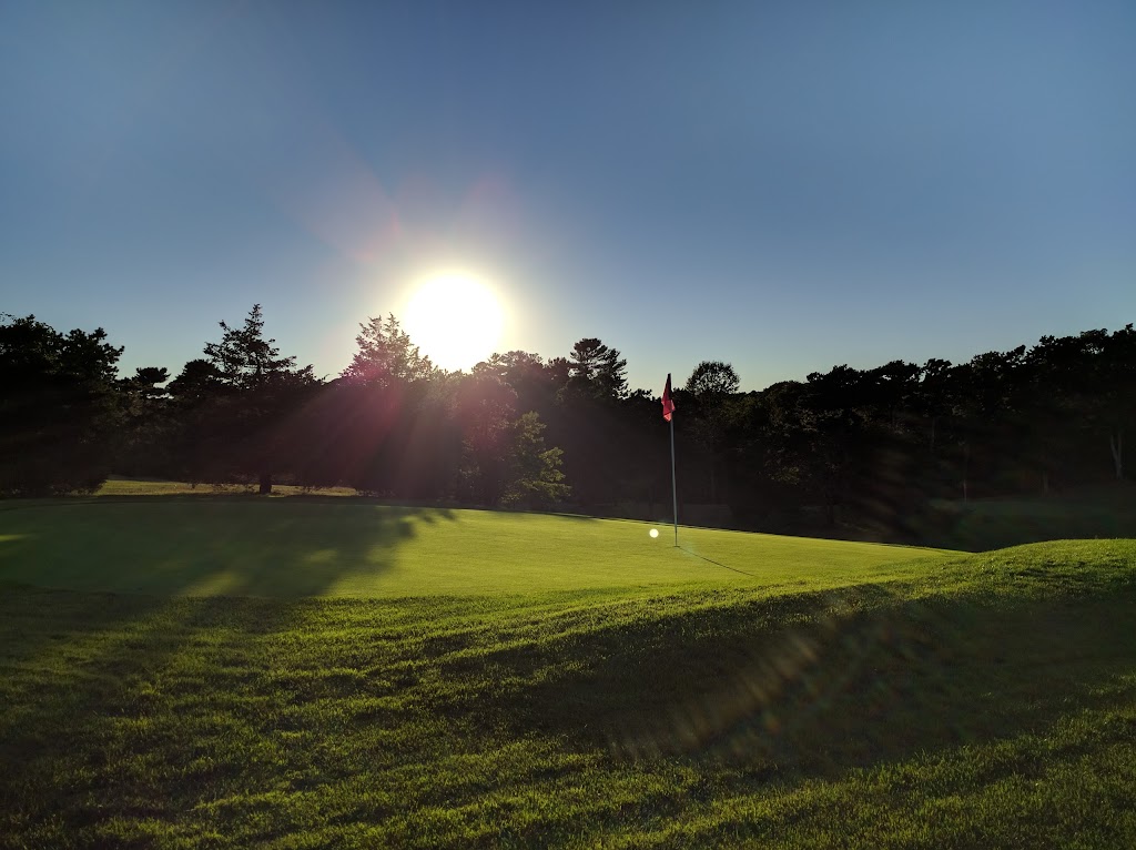 Panoramic view of a lush green golf course at Cotuit High Ground Golf Club. Smooth