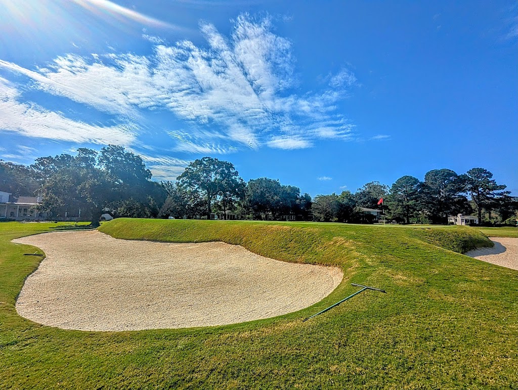 Panoramic view of a lush green golf course at Country Club of Charleston. Smooth