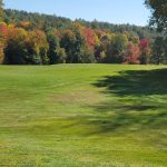 Panoramic view of a lush green golf course at Country Club of Greenfield. Smooth