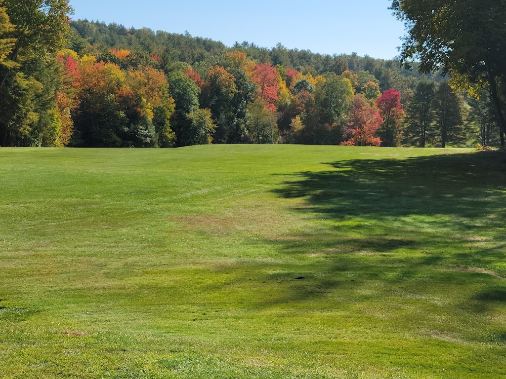 Panoramic view of a lush green golf course at Country Club of Greenfield. Smooth