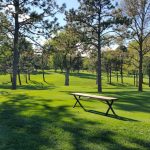 Panoramic view of a lush green golf course at Country Club of Lincoln. Smooth