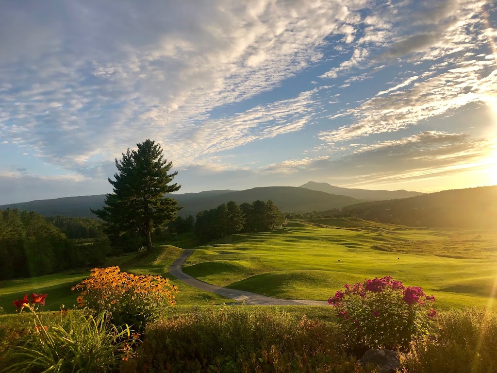 Panoramic view of a lush green golf course at Country Club of Vermont. Smooth