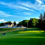 Panoramic view of a lush green golf course at Country Club of Waterbury. Smooth