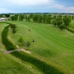 Panoramic view of a lush green golf course at Country Drive Golf Course. Smooth