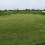 green grass with the flag in the hole.