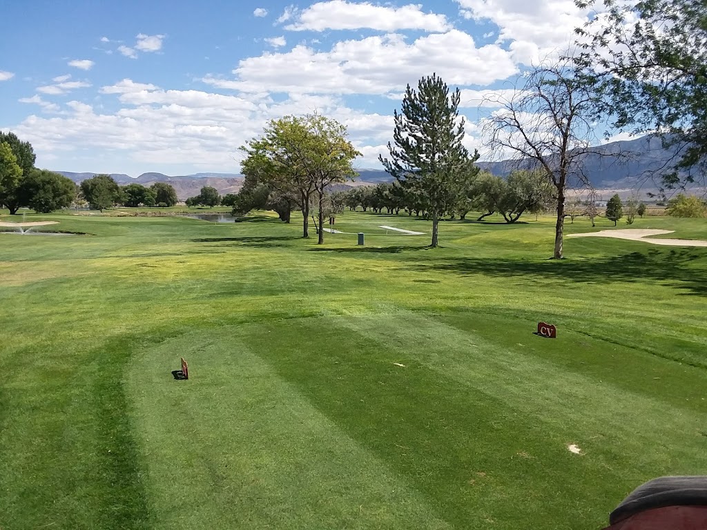 Panoramic view of a lush green golf course at Cove View Golf Course. Smooth