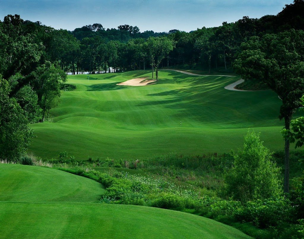 Panoramic view of a lush green golf course at Cowboys Golf Club. Smooth