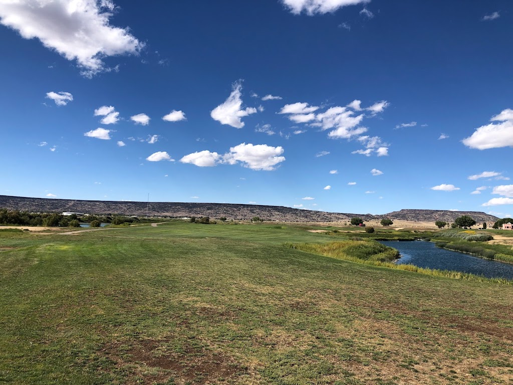 Panoramic view of a lush green golf course at Coyote Del Malpais. Smooth