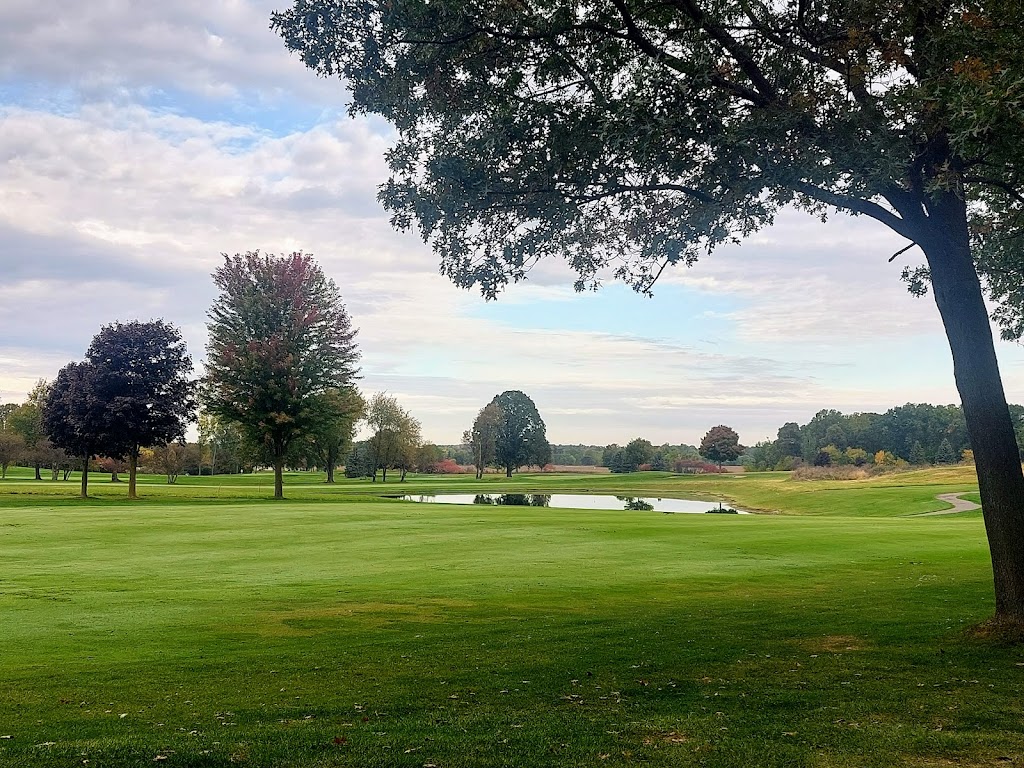 Panoramic view of a lush green golf course at Coyote Golf Club. Smooth