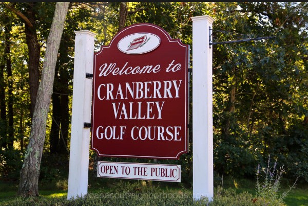Panoramic view of a lush green golf course at Cranberry Valley Golf Course. Smooth