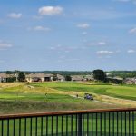 Panoramic view of a lush green golf course at Creekmoor Golf Course. Smooth