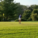 Panoramic view of a lush green golf course at Crescent Hill Golf Course. Smooth