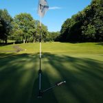 green grass with the flag in the hole.
