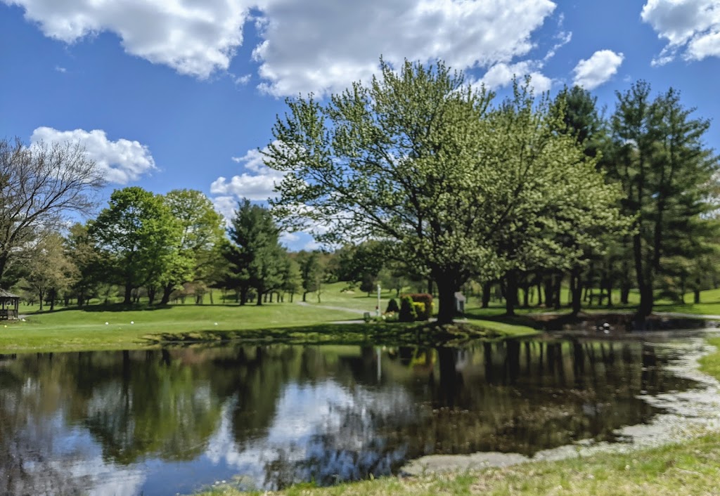 Panoramic view of a lush green golf course at Crestbrook Golf Course. Smooth