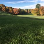 Panoramic view of a lush green golf course at Crestview Country Club. Smooth