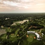 Panoramic view of a lush green golf course at Crestview Country Club. Smooth