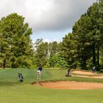 Panoramic view of a lush green golf course at Crooked Hollow Golf Club. Smooth