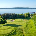 Panoramic view of a lush green golf course at Crooked Tree Golf Club. Smooth