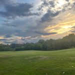 Panoramic view of a lush green golf course at Cross Creek Golf Club. Smooth