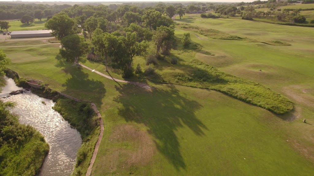 Panoramic view of a lush green golf course at Cross Creek Golf Links. Smooth