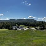 Panoramic view of a lush green golf course at Crotched Mountain Golf Club. Smooth