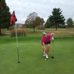 green grass with the flag in the hole.