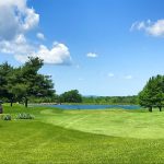 Panoramic view of a lush green golf course at Crown Pointe Golf Club. Smooth