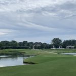 Panoramic view of a lush green golf course at Cypress Lakes Golf & Tennis. Smooth