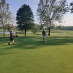 green grass with the flag in the hole.