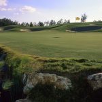 Panoramic view of a lush green golf course at Cypress Ridge Golf Course. Smooth