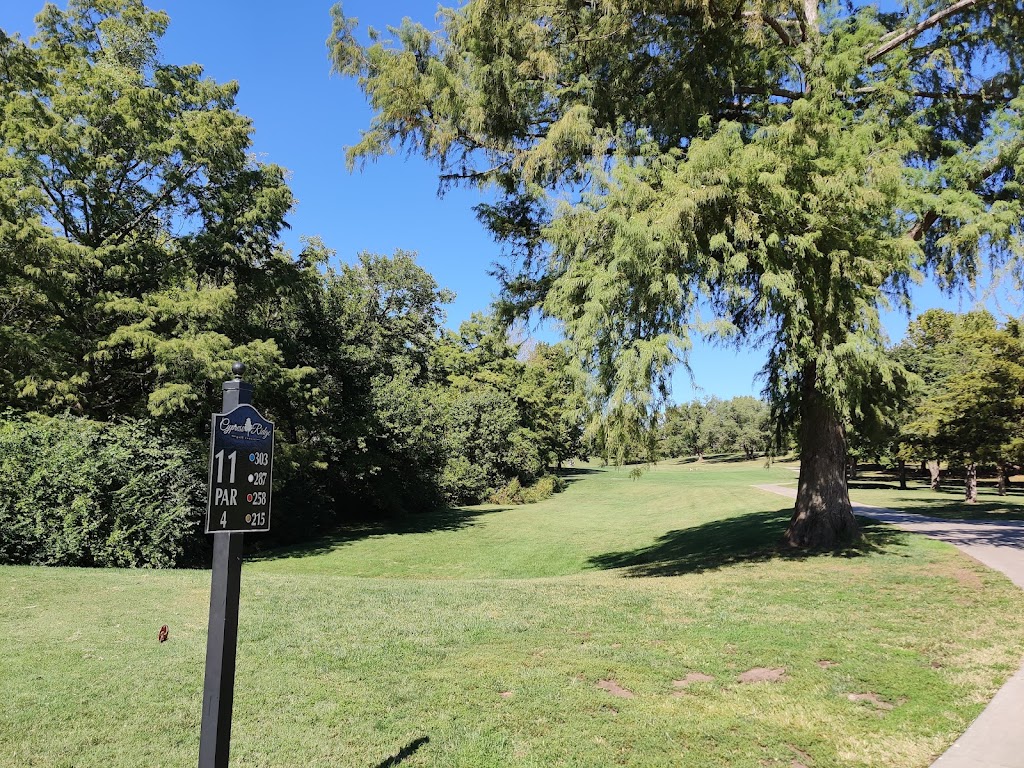Panoramic view of a lush green golf course at Cypress Ridge Golf Course. Smooth