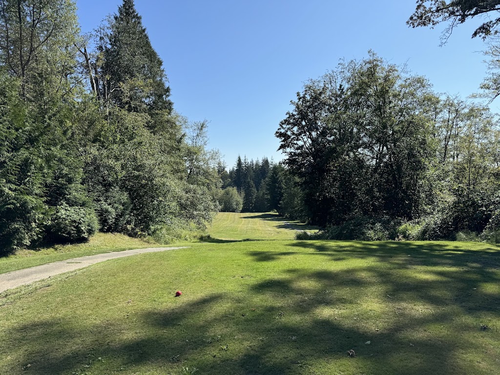 Panoramic view of a lush green golf course at Dakota Creek Golf Course. Smooth