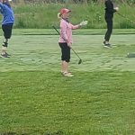 green grass with the flag in the hole.