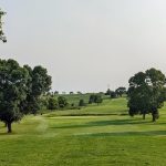 Panoramic view of a lush green golf course at Daytona Golf Club. Smooth